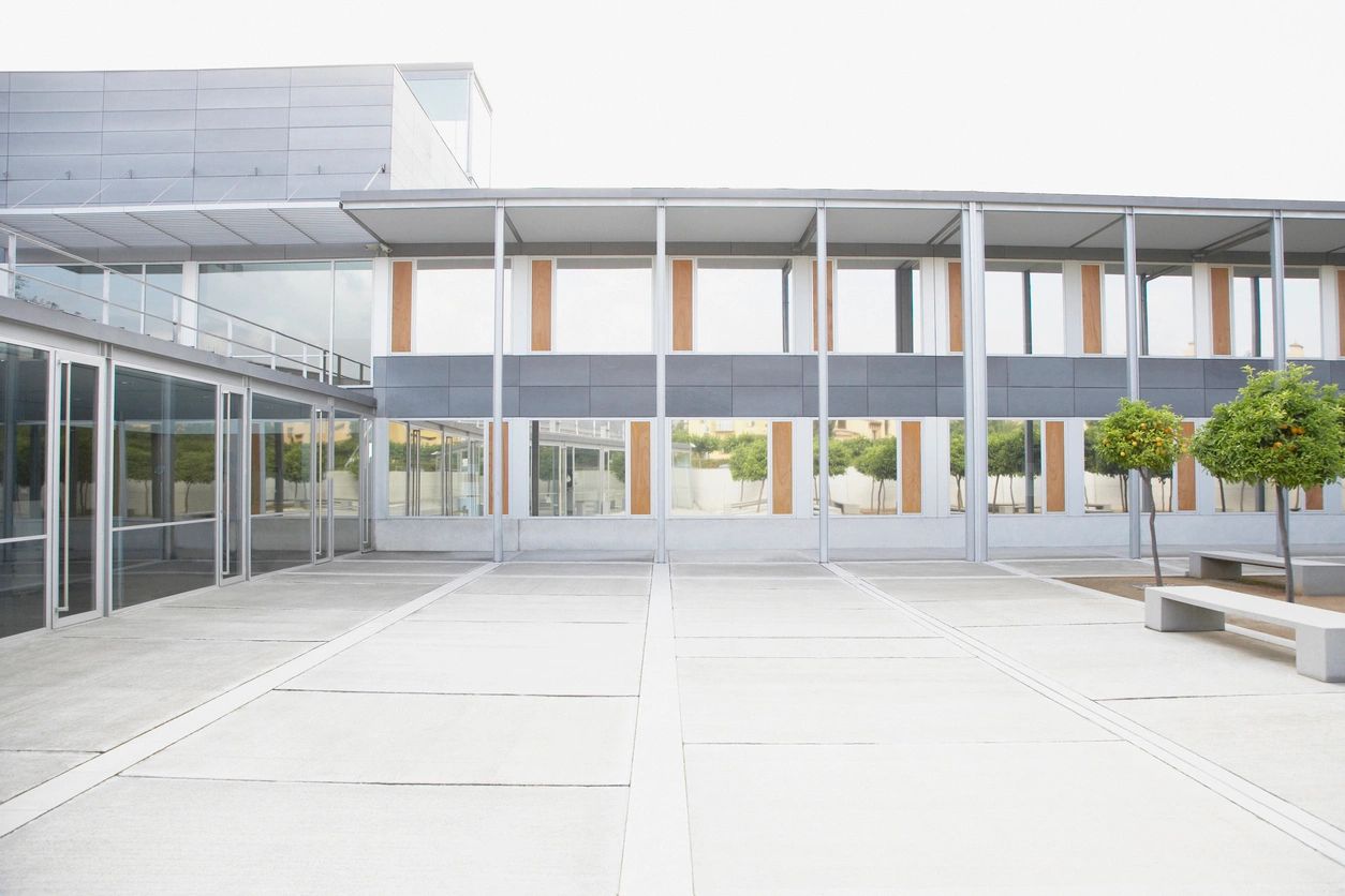 A large empty parking lot with lots of windows.