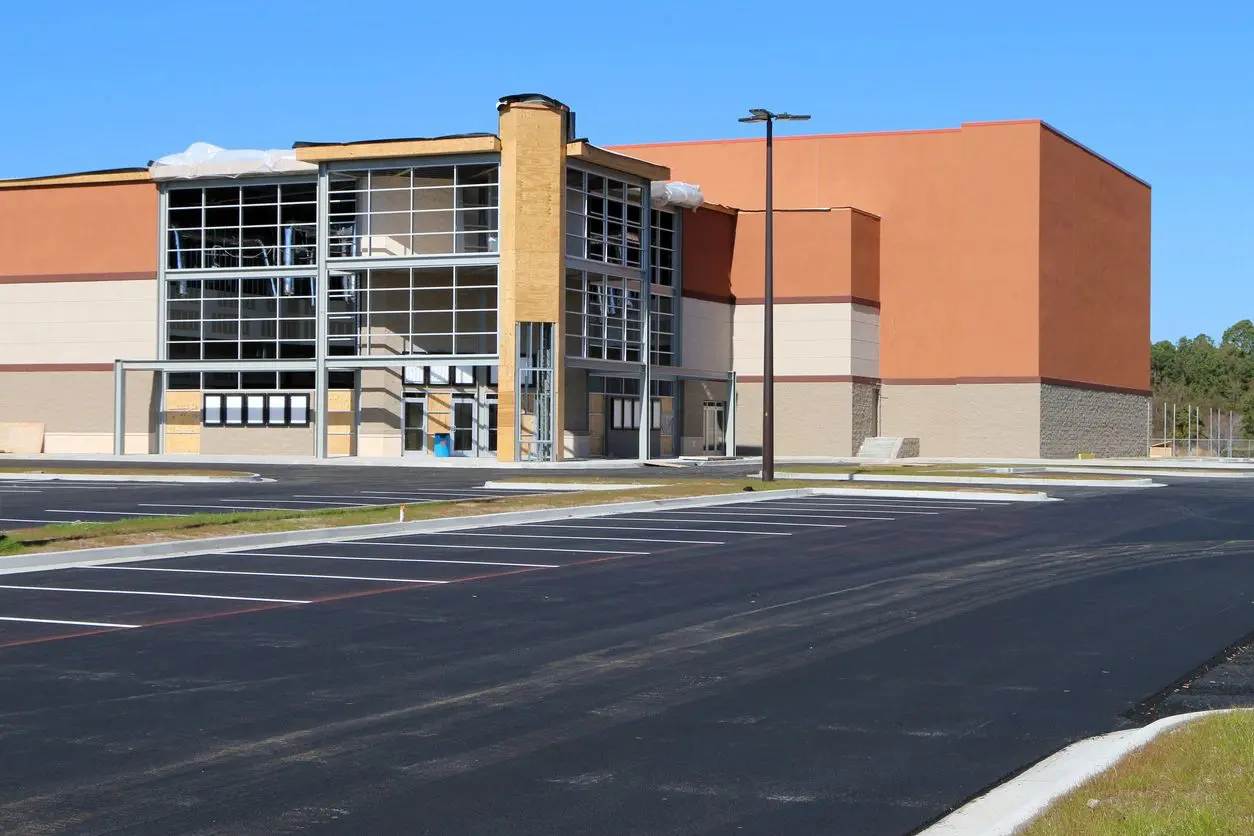 A large building with a parking lot in front of it.