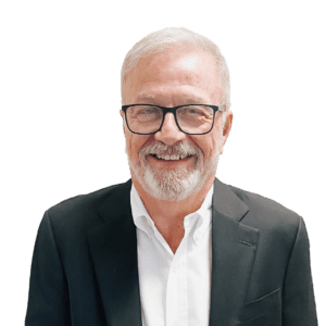 A man with white hair and glasses wearing a suit.